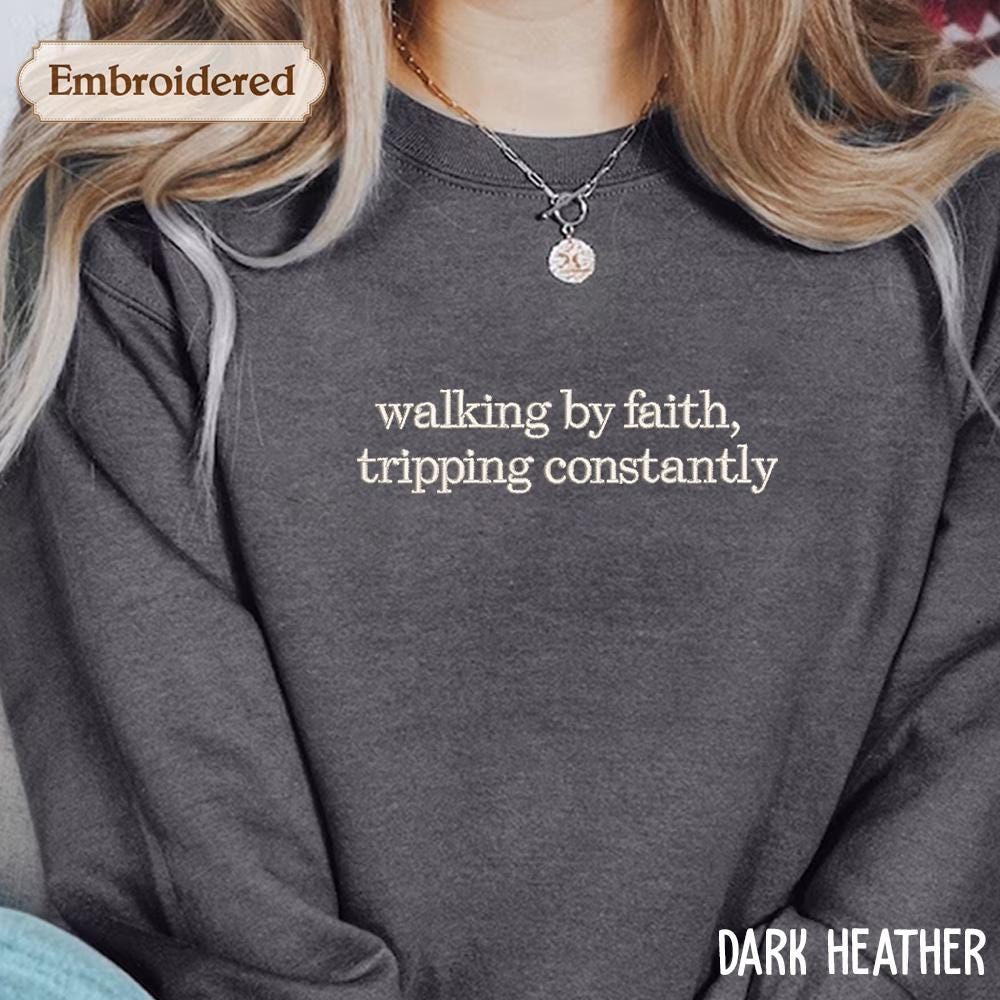 a woman wearing a shirt that says walking by faith, tripping constantly
