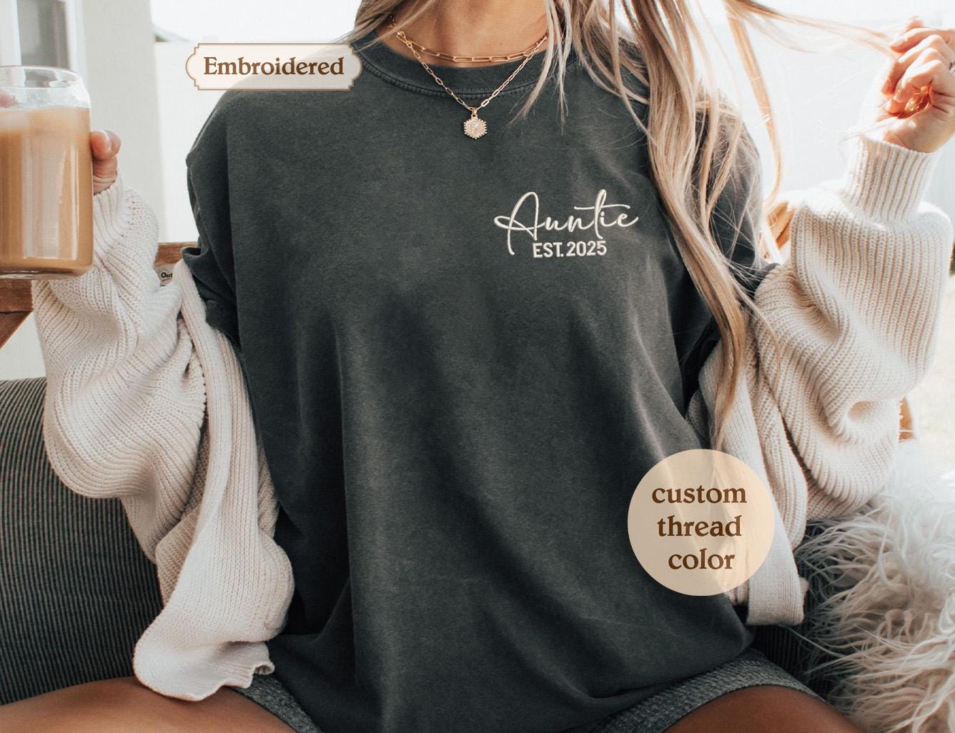 a woman sitting on a couch holding a cup of coffee
