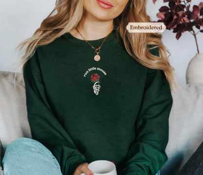 a woman sitting on a couch holding a cup of coffee
