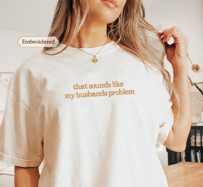 a woman wearing a t - shirt that says, that sounds like my husband &#39;