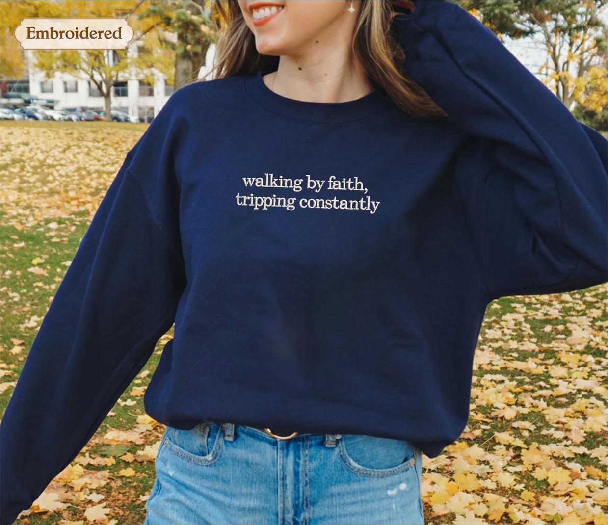 a woman wearing a sweatshirt that says walking by path, tripping constantly