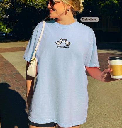 a woman in a blue shirt holding a cup of coffee